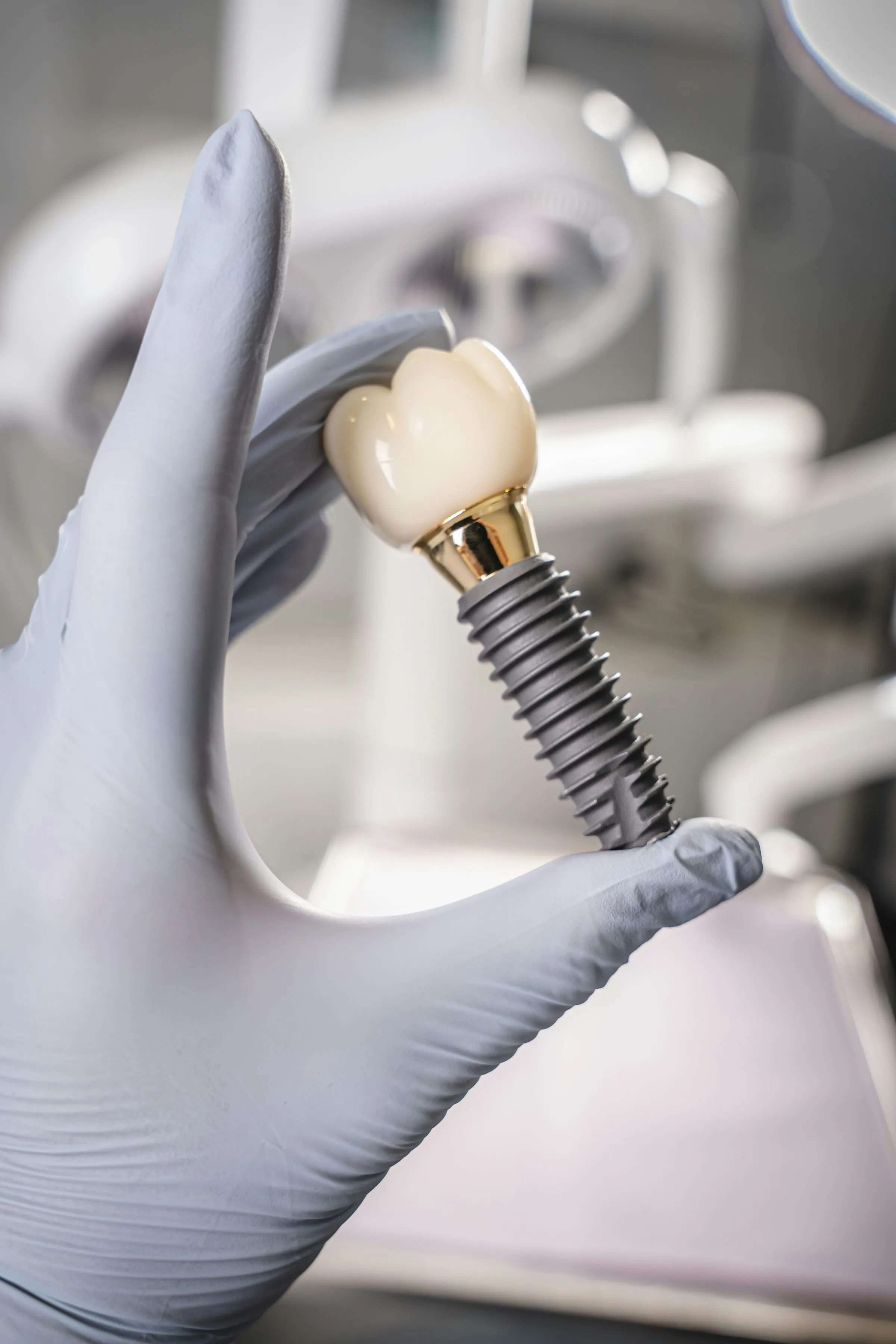 Implant and crown held in a gloved hand