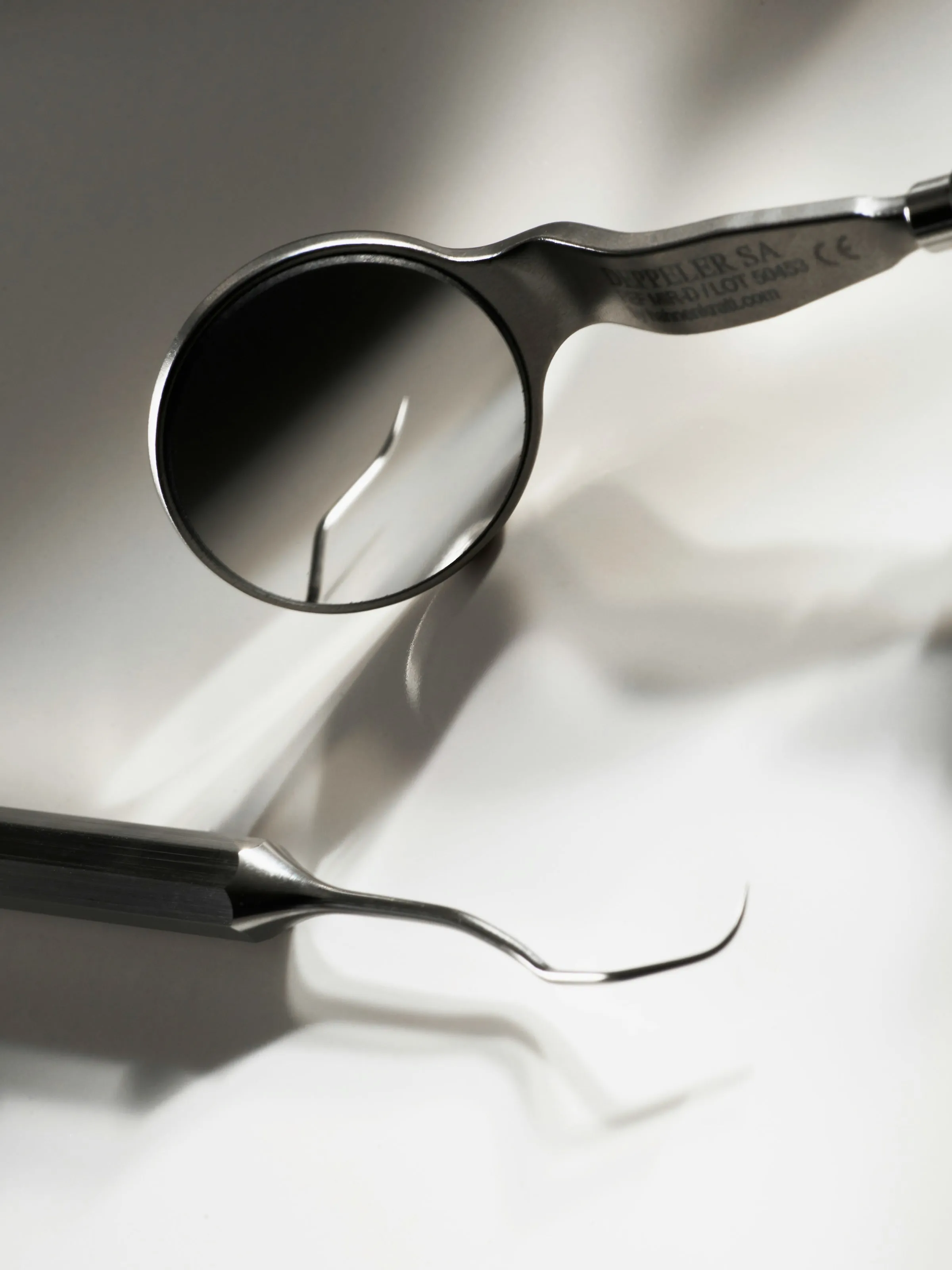 A dental mirror and explorer, black and white