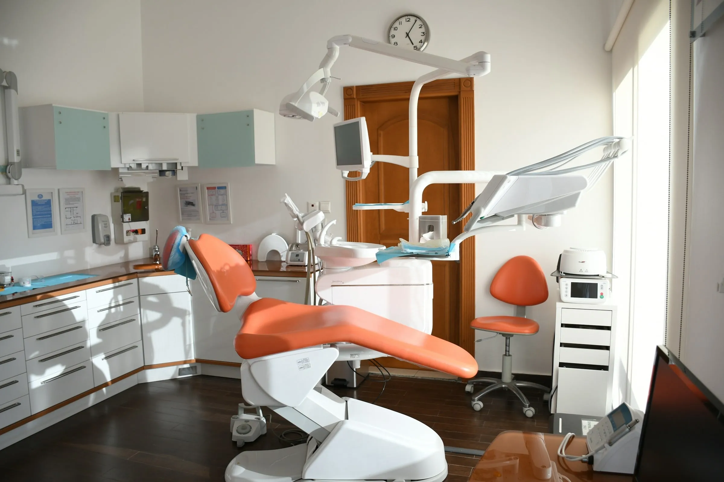 Treatment room with an orange dental chair